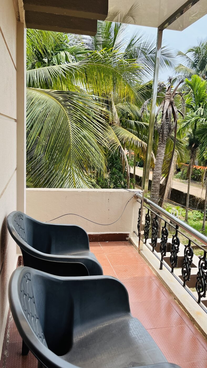 Private balcony seating with palm views