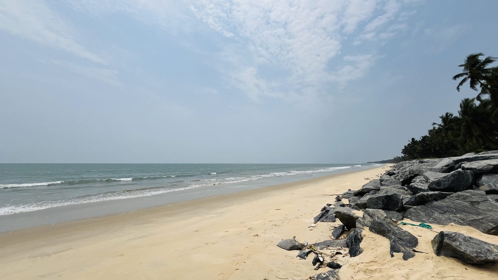 Malpe beach shoreline with rock breakwater