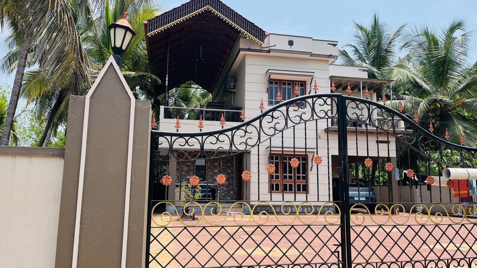 Aashirwad Beach Villa gate at dusk with festive garlands
